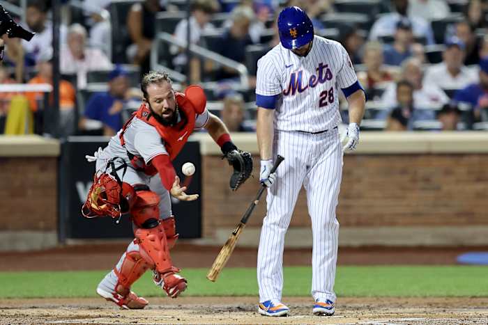 Mets hitter Darin Ruf looks down at the ground after striking out. (2022)